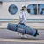 Lifestyle outdoor action shot of a traveler walking with the XCMAN adjustable length padded snowboard bag