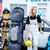 Lifestyle outdoor action shot of a traveler standing next to the XCMAN roller snowboard bag and equipment near a vehicle