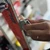 Side profile action shot showing the XCMAN base edge file guide sliding along a ski edge for precision sharpening