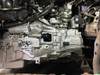 Wide installed view of JBtuned Honda Fit GE8 K-swap clutch line showing the master-to-slave hydraulic line routing across the K-Series transmission in the engine bay.