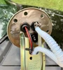 Underside view of an EG Civic and 1994-1995 Integra JBtuned fuel pump hanger upgrade showing in-tank plumbing and electrical wiring.
