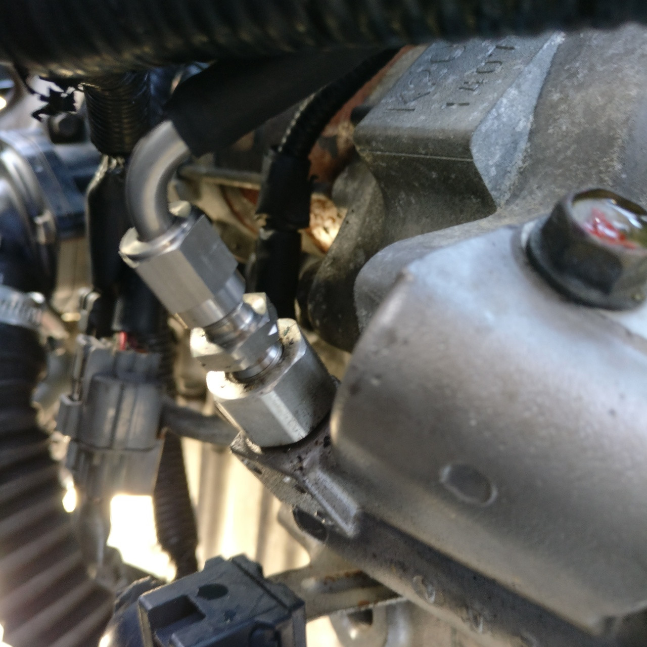 Close-up of JBtuned K-swap hydraulic clutch line connection at the K-Series transmission slave-cylinder assembly.