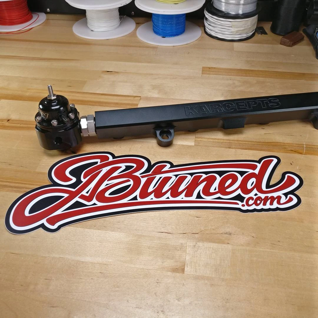 Installed JBtuned ORB-to-ORB adapter connecting an AEM adjustable fuel pressure regulator directly to an aftermarket fuel rail.