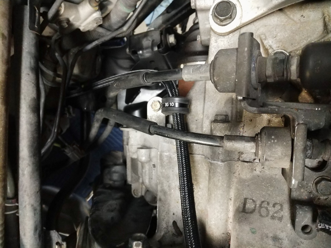 Using existing transmission bracket to hold down return line