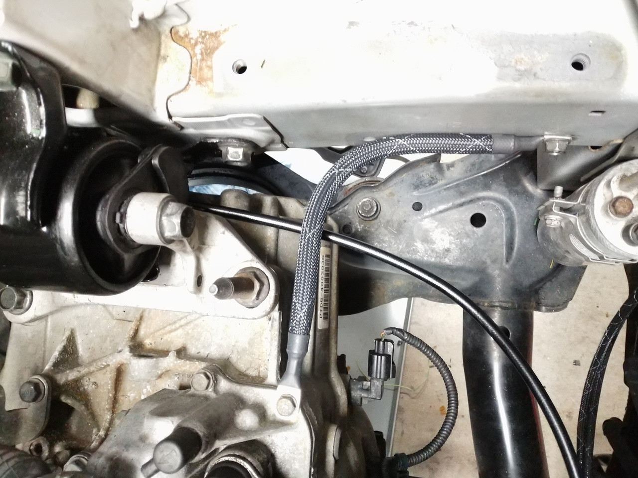 Installed JBtuned RSX DC5 full clutch line showing the hydraulic line routed beneath the transmission mount.