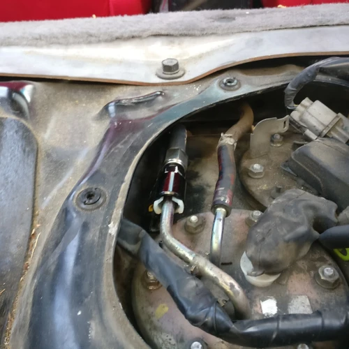 JBtuned 6AN tank-to-OEM-filter fuel line routed beneath the factory Honda underbody fuel-line cover - angle 1