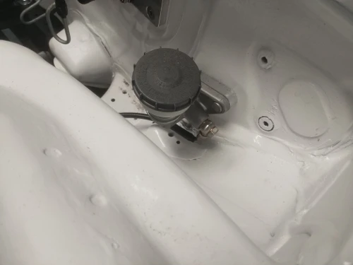 Close-up of JBtuned J-swap clutch line connected to the S2000 clutch master cylinder with stainless-steel connection hardware.