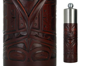 Red-brown recycled glass grinder with West Coast First Nations chieftain design. Red-brown recycled glass grinder with West Coast First Nations chieftain design.