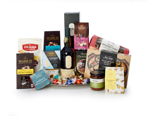 Gourmet gift basket featuring Lagavulin single malt scotch, sweet and savoury snacks (chocolate, crackers, nuts, etc.), presented on a silver tray.