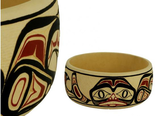 Potlatch bowl carved in West Coast First Nations dogfish design, with red, black, and cream colours.