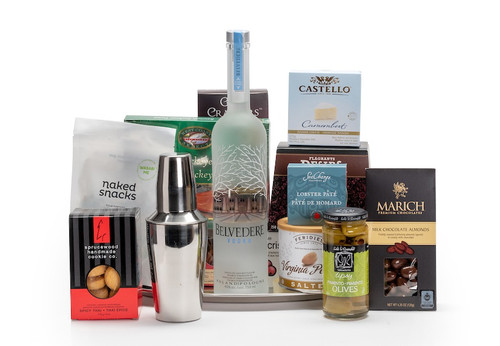 Gourmet gift basket featuring Belvedere vodka, a martini shaker, and snacks (crackers, cheese, pate, etc.).