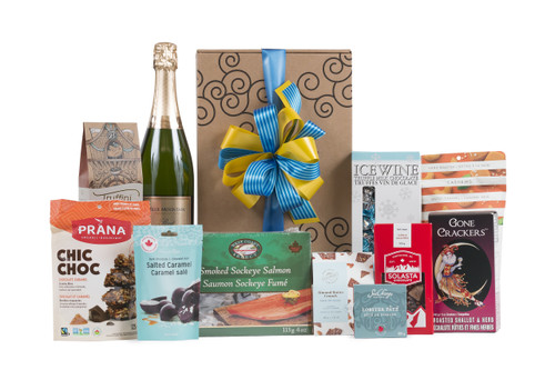 Gourmet gift basket featuring Blue Mountain Gold Label Brut Sparkling Wine, and sweet and savoury snacks (chocolate, crackers, nuts, etc.), packaged in signature Green & Green gift box with ribbon and bow.