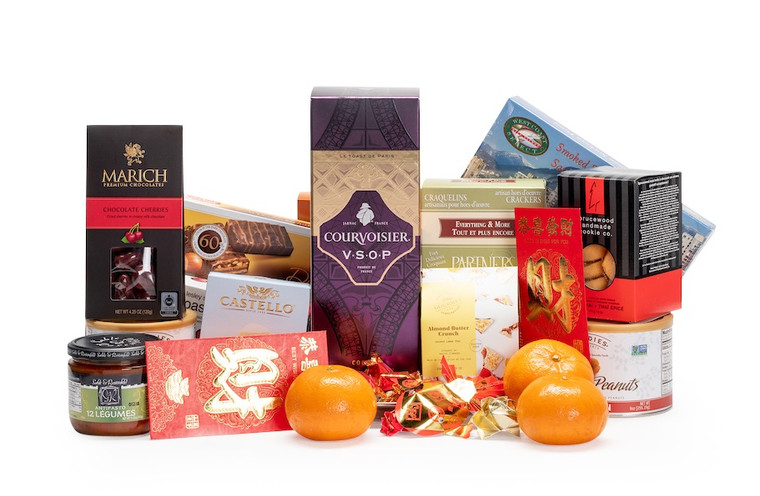Gourmet gift basket featuring Courvoisier cognac, sweet and savoury snacks (chocolate, crackers, nuts, etc.), mandarins, and lucky red envelopes, presented on a silver tray.