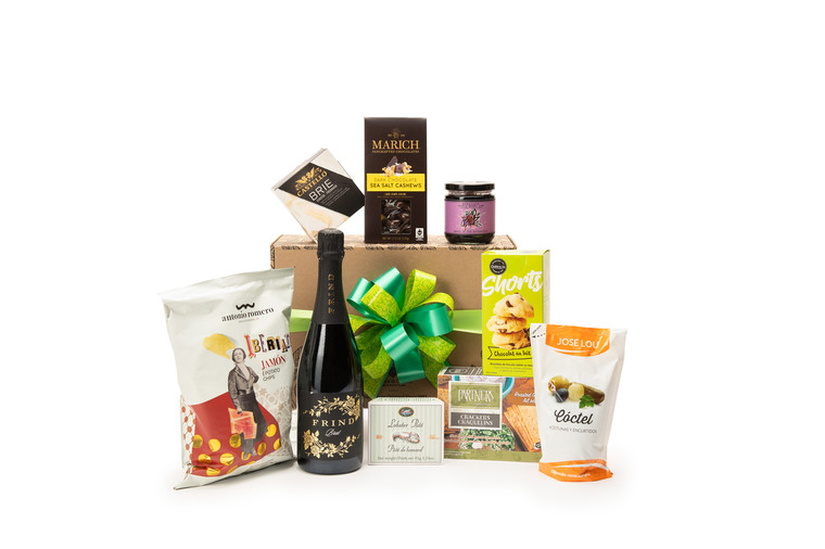 Gourmet sparkling wine gift box featuring Frind Brut Sparkling Wine paired with sweet and savoury snacks (chocolate, crackers, nuts, etc.), packaged in signature Green & Green gift box with ribbon and bow.