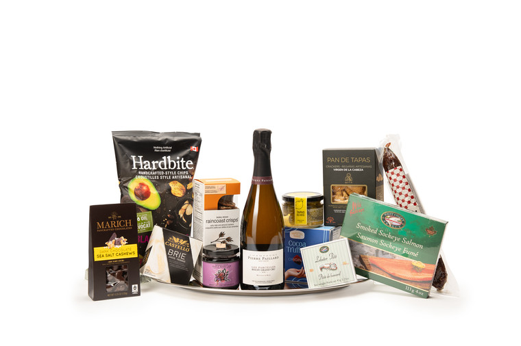 Gourmet Champagne gift box featuring Pierre Paillard Les Parcelles Bouzy Grand Cru Champagne paired with sweet and savoury snacks (chocolate, crackers, nuts, etc.), packaged in signature Green & Green gift box with ribbon and bow.
