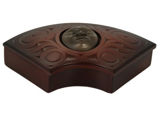 Red-brown recycled fan box with West Coast First Nations sun design.