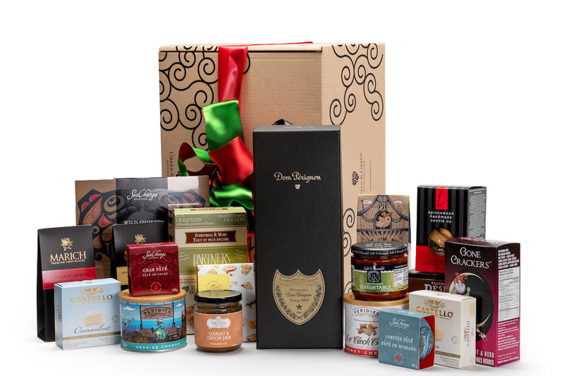 Gourmet gift basket featuring Moet & Chandon Dom Perignon champagne, and BC local snacks (chocolate, crackers, smoked salmon, etc.), packaged in signature Green & Green gift box with red and green ribbon and bow.