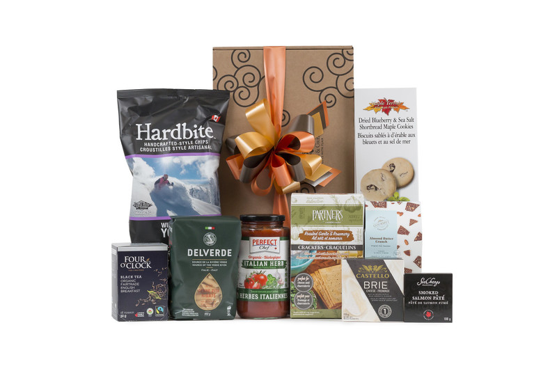 Gourmet gift basket featuring nutritious snacks (chocolate, tea, nuts, etc.) packaged in signature Green & Green gift box with ribbon and bow.