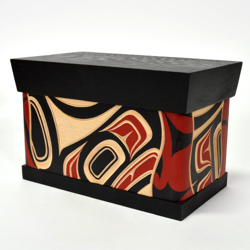 Eagle ChestSize: 9" x 5.5" x 5" 
Carved and painted steam bent yellow cedar with red cedar top and bottom 

Design meaning: Honor. Power. Leadership

Bentwood boxes are one of the most outstanding items manufactured by Native people of the Pacific Northwest Coast, including parts of southern Alaska, western British Columbia and southern Washington. Made by kerfing and steam bending a single plank to form four sides, the containers with a height greater than their width are called boxes, while those with a length greater than their height are referred to as chests.  Historically, boxes came in various sizes from small (measured in inches) to massive (large enough to provide seating). Some undecorated, others carved or painted or both. The highly decorated ones were symbols of wealth. Fishermen used boxes shaped to fit into their canoes to carry tackle and supplies. Some were used for cooking (filled with water and hot stones) while others were used for storage of food, clothing, tools, or supplies.  
