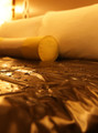 Waterproof sheet laid over a hotel bed, glistening with water droplets.