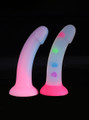 Suction-based pastel dildos shown side by side on black background