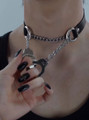 Close-up of collar worn on neck with handcuffs at center