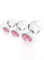 Pink gem crystal glass butt plug set in three sizes with clear glass bodies and faceted pink jewel bases