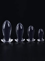 Clear TPE anal dragon egg butt plug size range standing on a black background