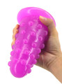 Purple XL nubbed PVC butt plug held upside down to show its wide flared safety base