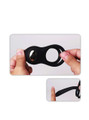 Flexible silicone vibrating cock ring shown stretched by hand with soft elastic body