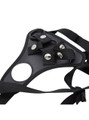 Close-up of black faux leather harness front panel with snap fasteners and ring hardware.