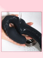 Waterproof black silicone double penetration vibrator being rinsed under running water