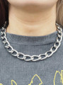 Silver chunky oval-link necklace worn around neck