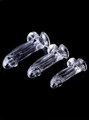 Small, Medium and Large clear realistic dildos with balls and suction cups lying on black background