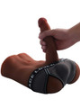 Tan male sex doll cock held by hand while wearing black underwear
