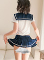 Roleplay outfit featuring a midriff-baring sailor top with a large bow, blending classic and modern styles.