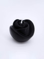 Close-up of the black, rose-patterned candle, symbolizing purity and passion.