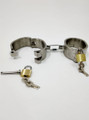 Side view of stainless steel handcuffs, highlighting the durable construction and locking system.