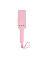 Pink leather paddle laid flat, showcasing its pastel color and premium material.