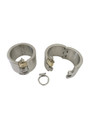 Close-up of heavy-duty stainless steel slave handcuffs with locking padlocks and D-rings.