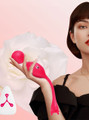 Woman holding pink kegel toy with remote, elegant floral backdrop