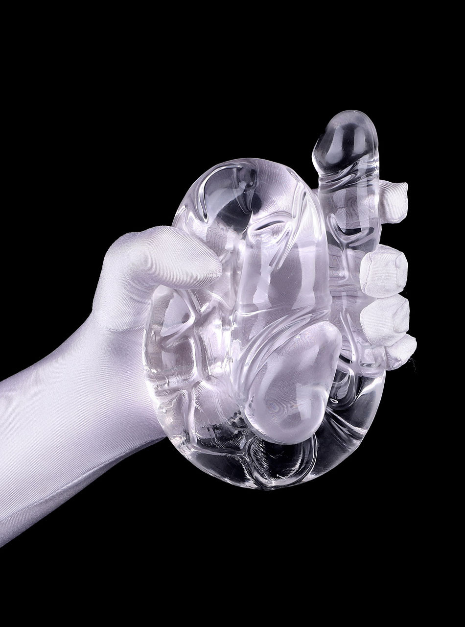 Crystal-clear double dildo gripped with hand showing texture