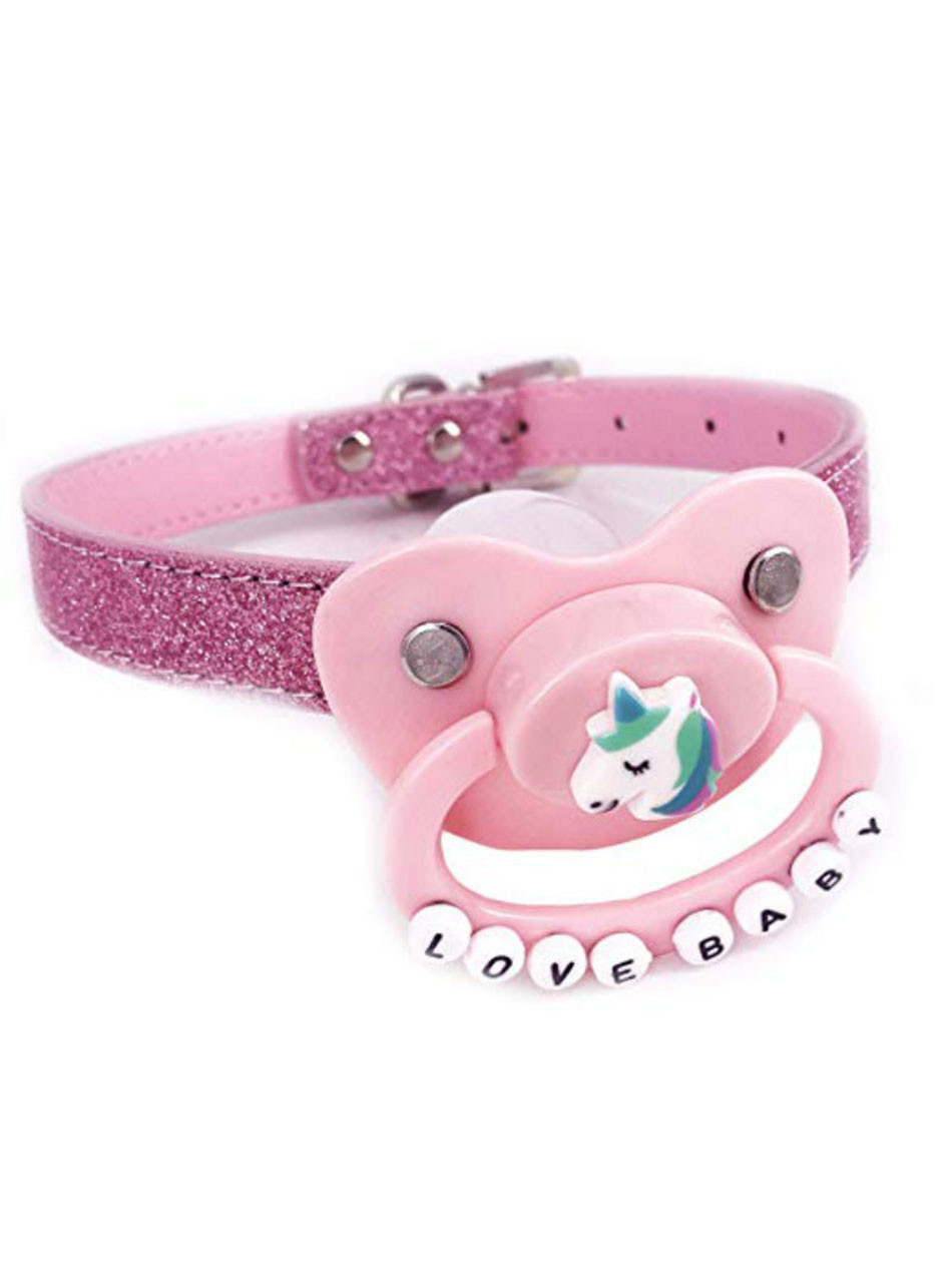 Adult pacifier gag with pastel pink unicorn design, glitter PU leather strap, and "LOVE BABY" letter beads, designed for ABDL or kink play.