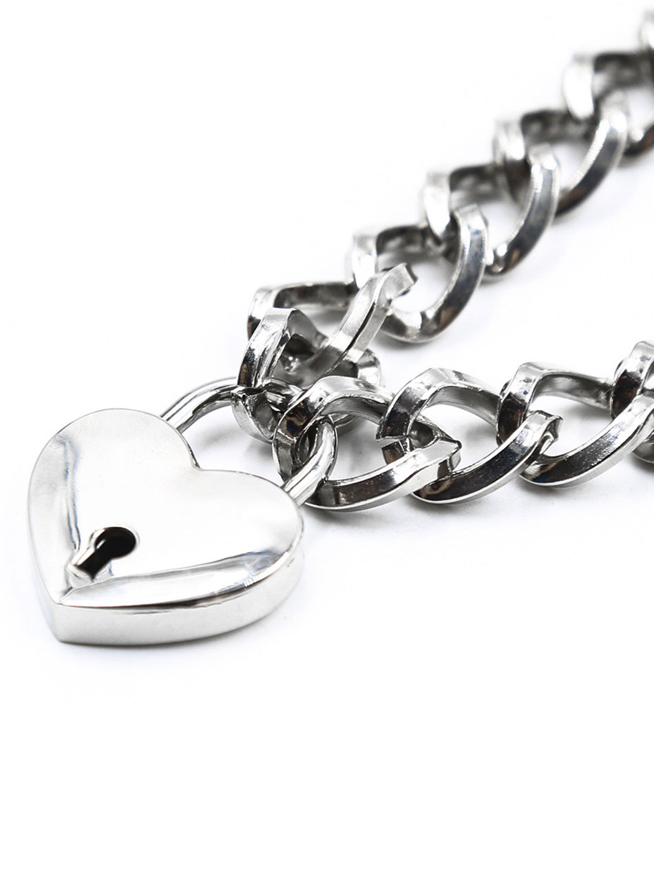 Close-up of silver heart padlock and chain links