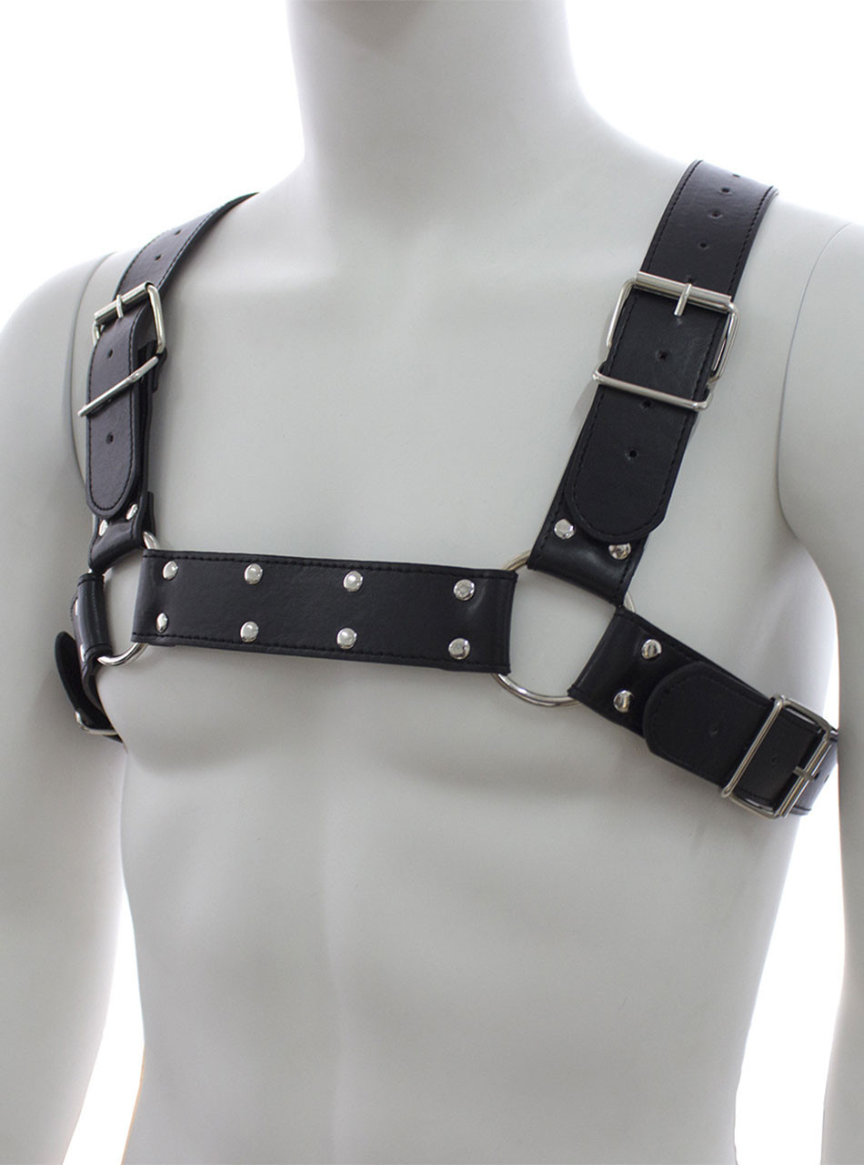 Angled close-up of black faux leather chest harness with silver buckles