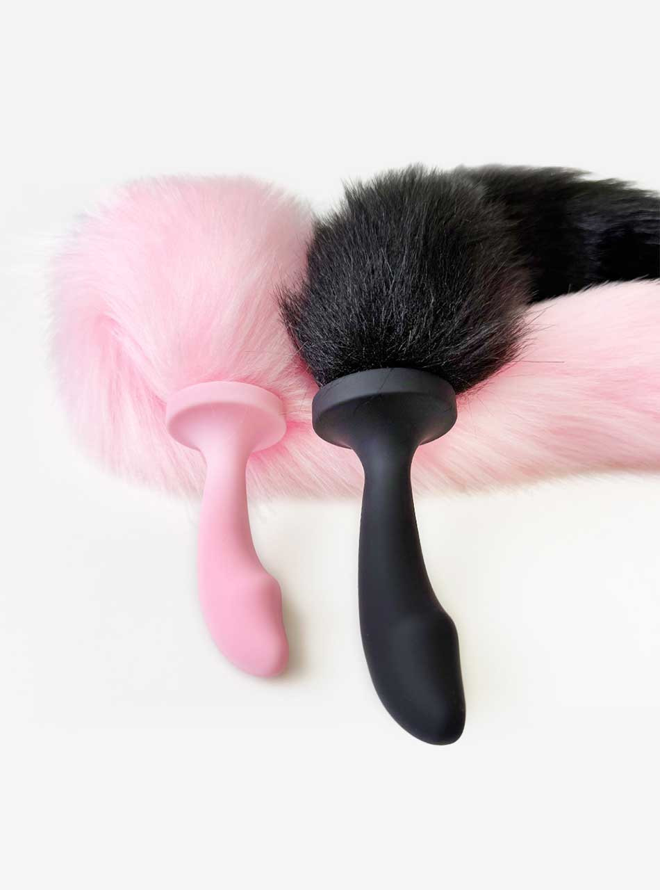 pink and black fluffy tail plugs close up