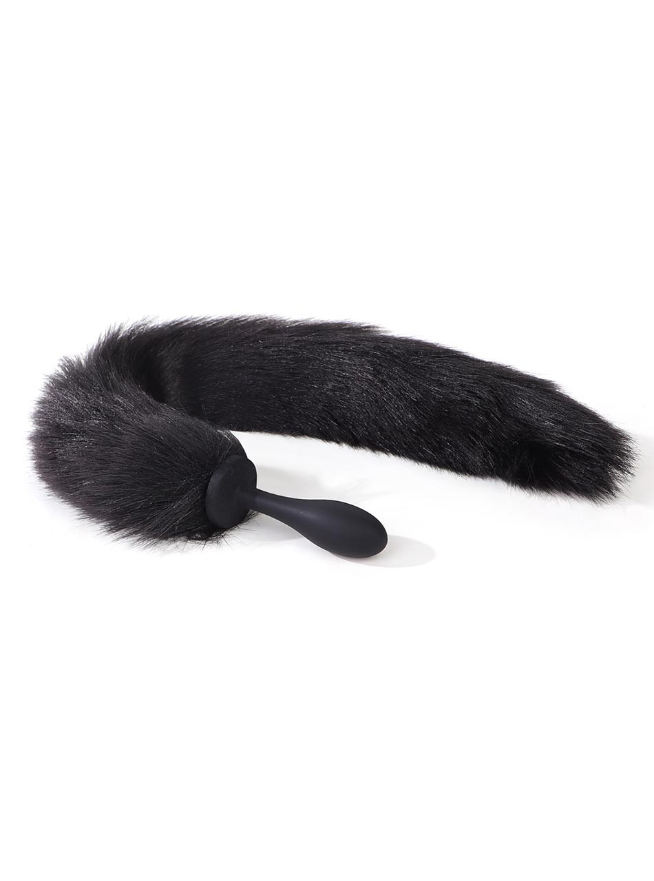 Curved black fox tail anal plug lying flat