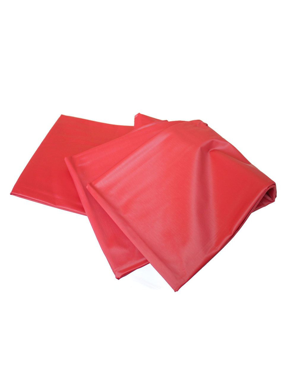 Folded and slightly open red waterproof sex sheet made of shiny, silky polystyrene.