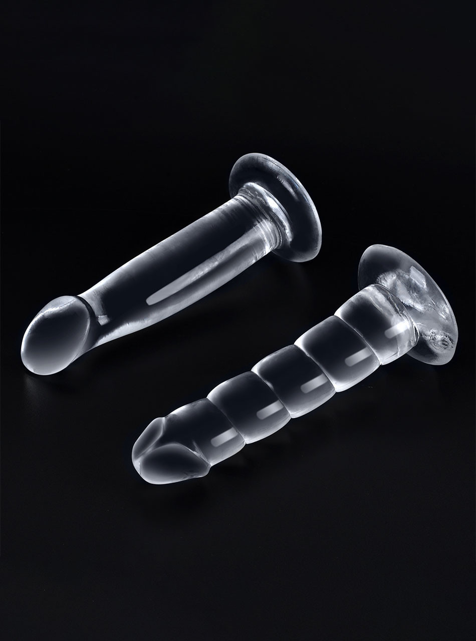 Clear flexible suction cup dildos in smooth and ribbed styles on black background