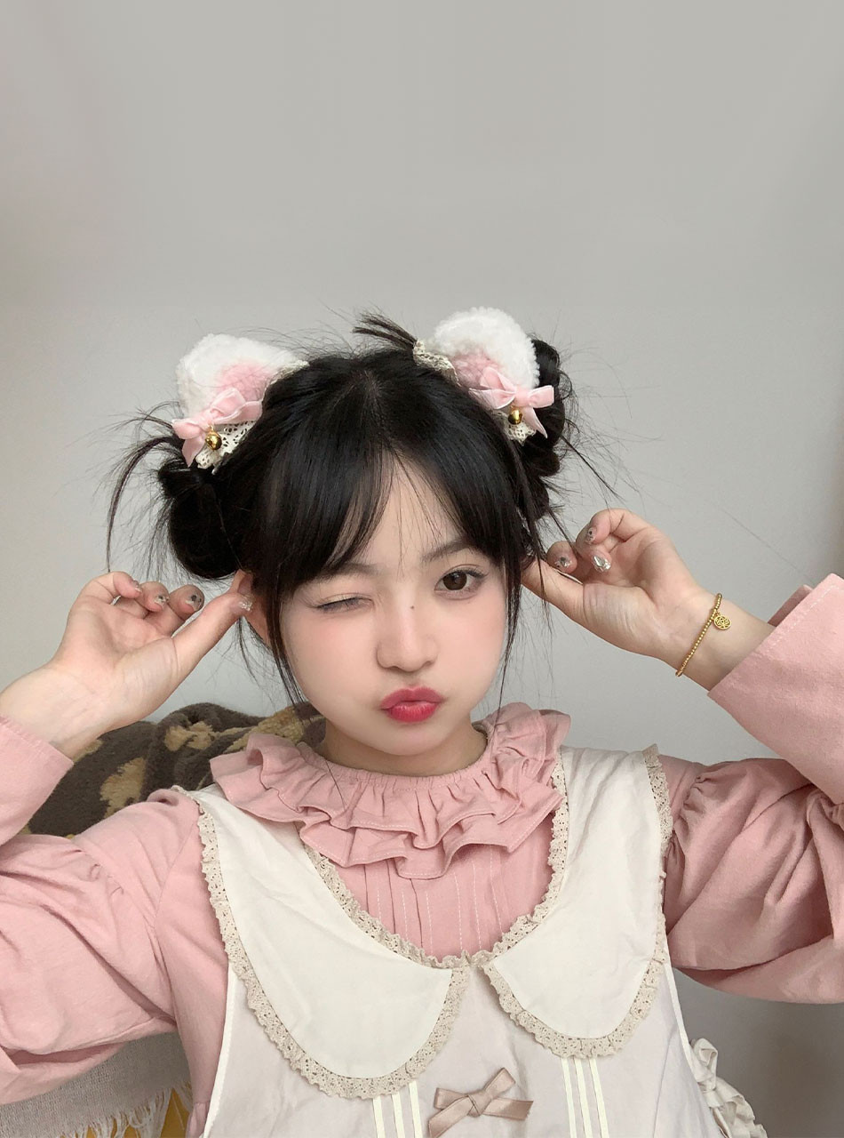 Plush cat ear headband in baby pink and white with small bells, perfect for ABDL and ageplay outfits.